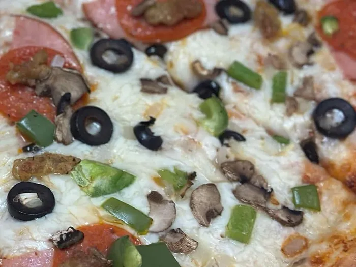 R7 combination pizza with olives, green peppers, mushrooms, sausage, pepperoni and Canadian bacon